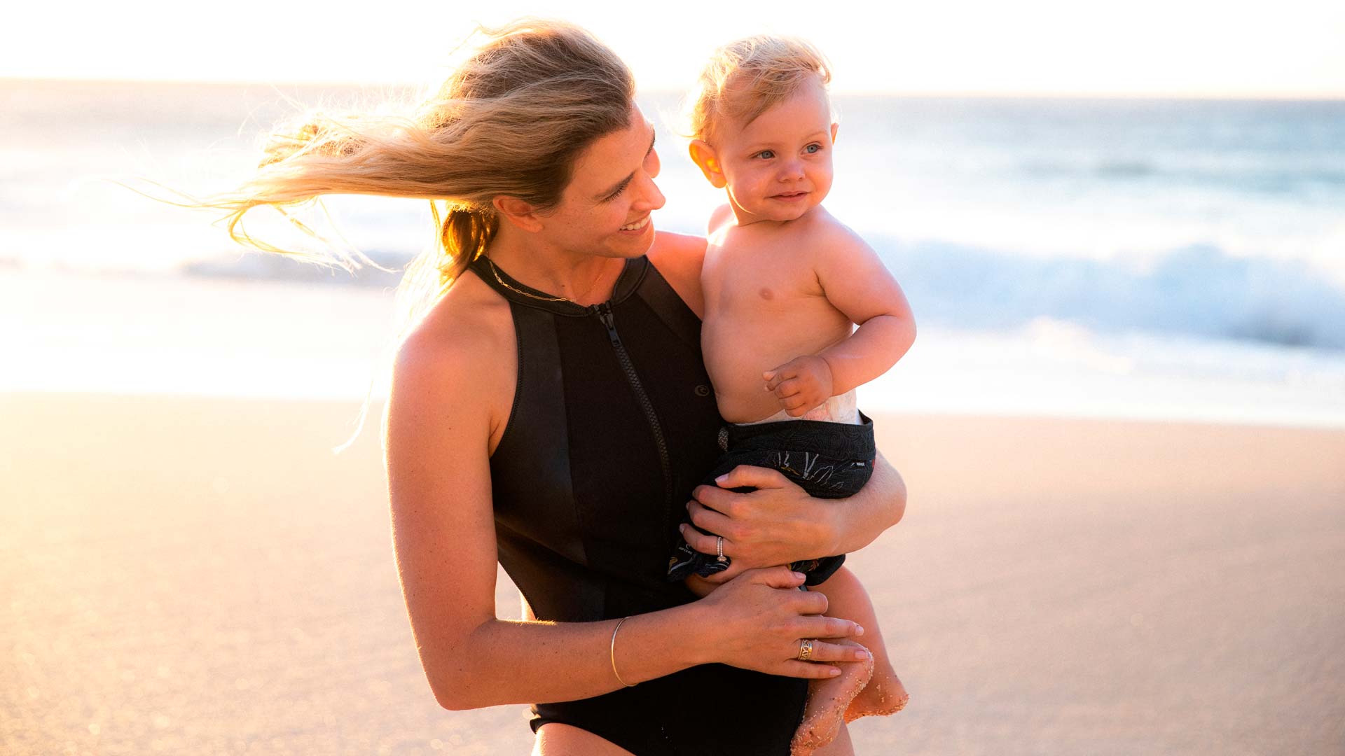 Rosy Hodge holding her son in Hawaii.