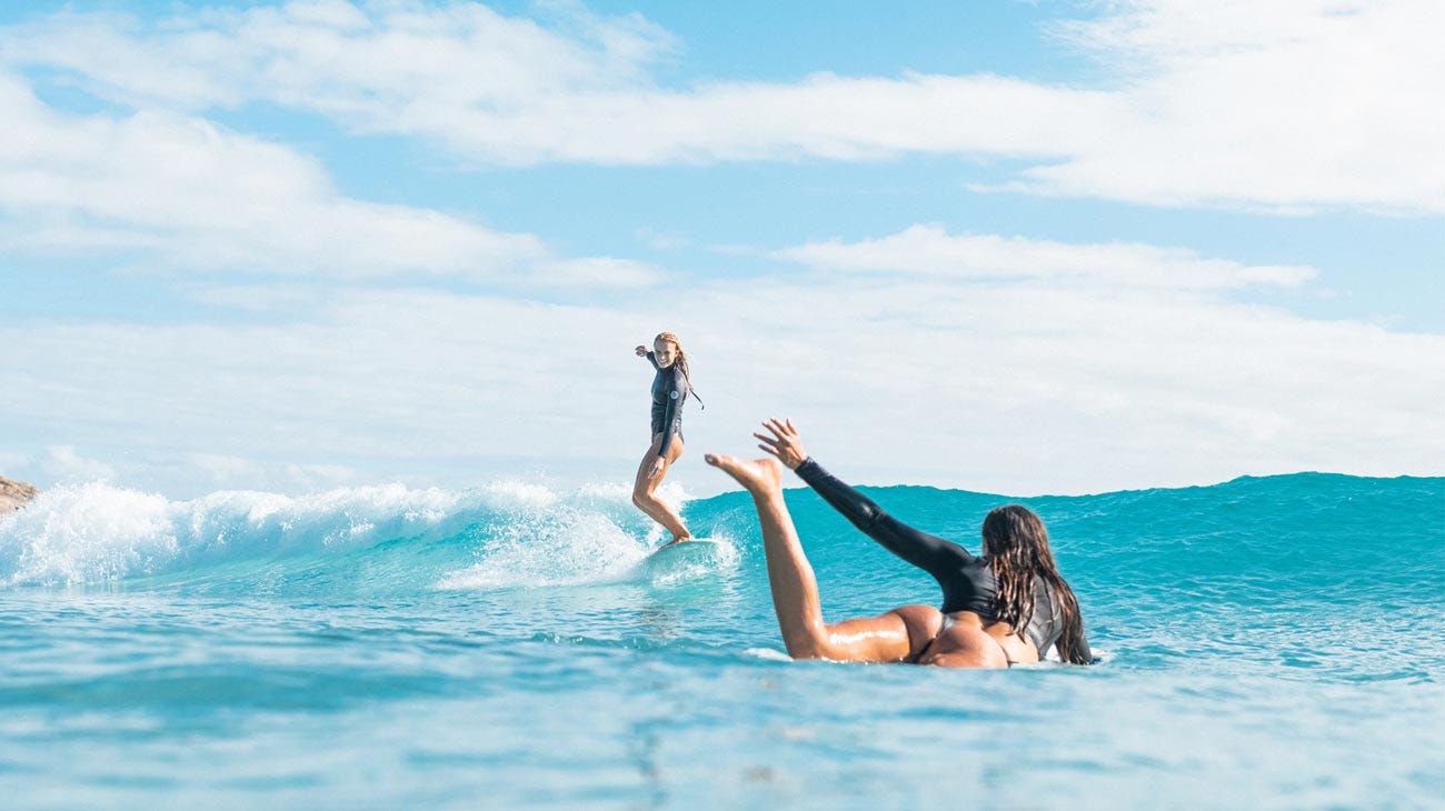 Jamaica and Kobie surfing together 