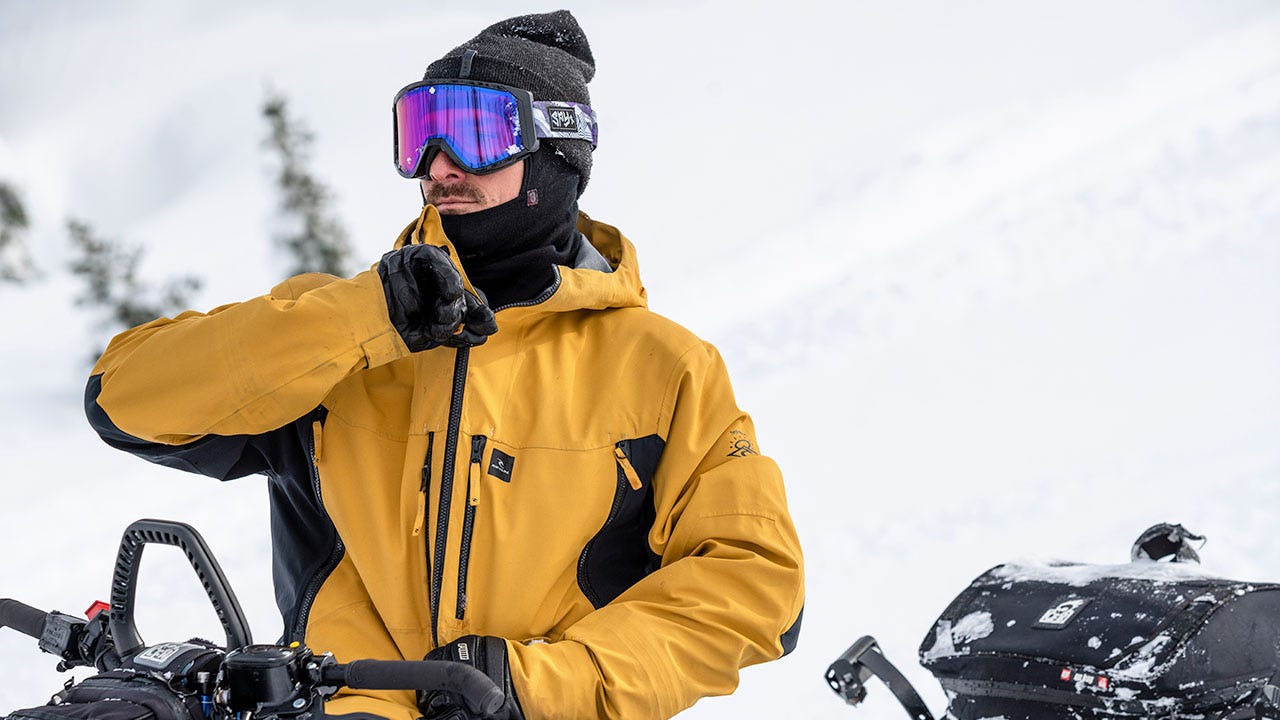 Rip Curl athlete wearing yellow snow jacket, googles and beanie