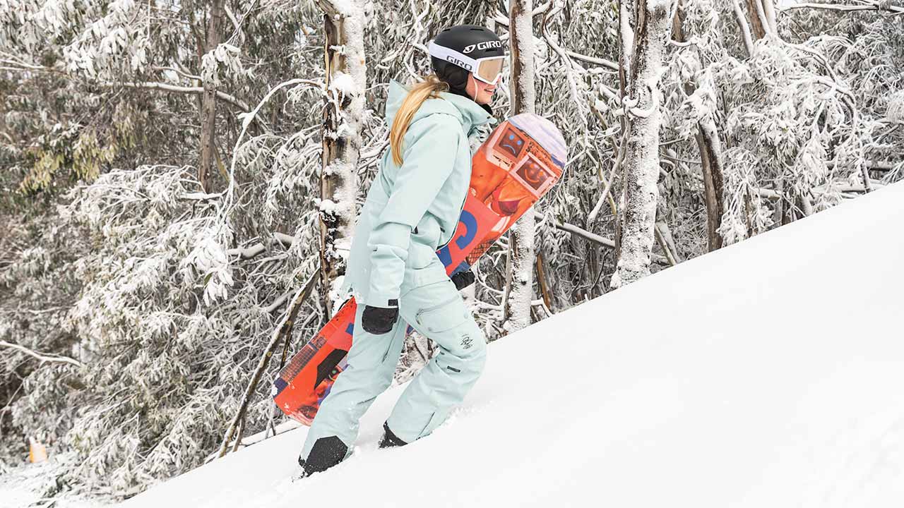 Rip Curl Snowboarder wearing light blue snow pants and bib.