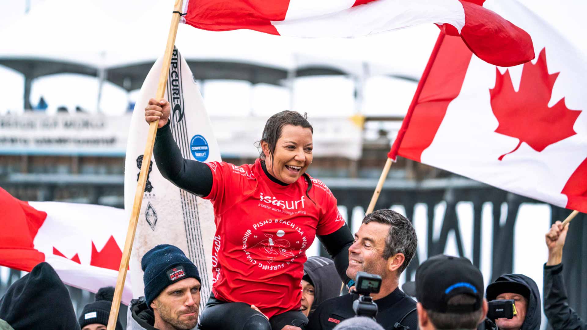 Victoria Feige waving the Canadian flag as she celebrates her win.