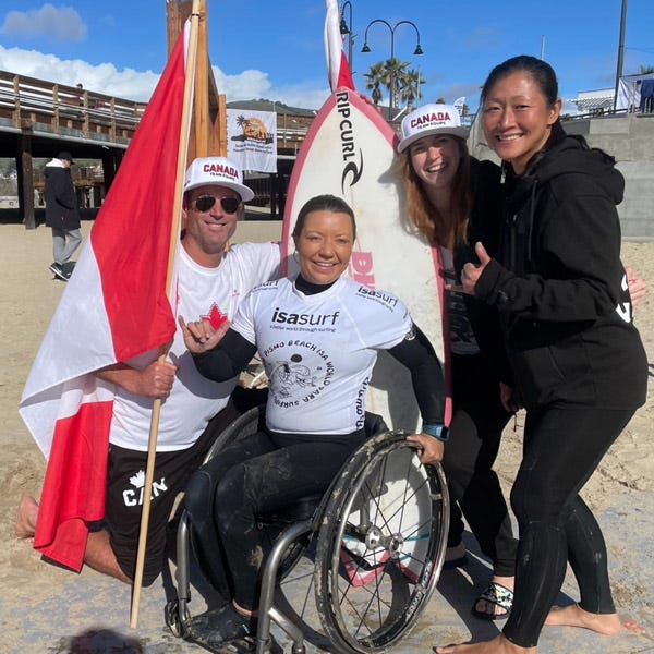 Para surfer Victoria Feige celebrating her win with friends.