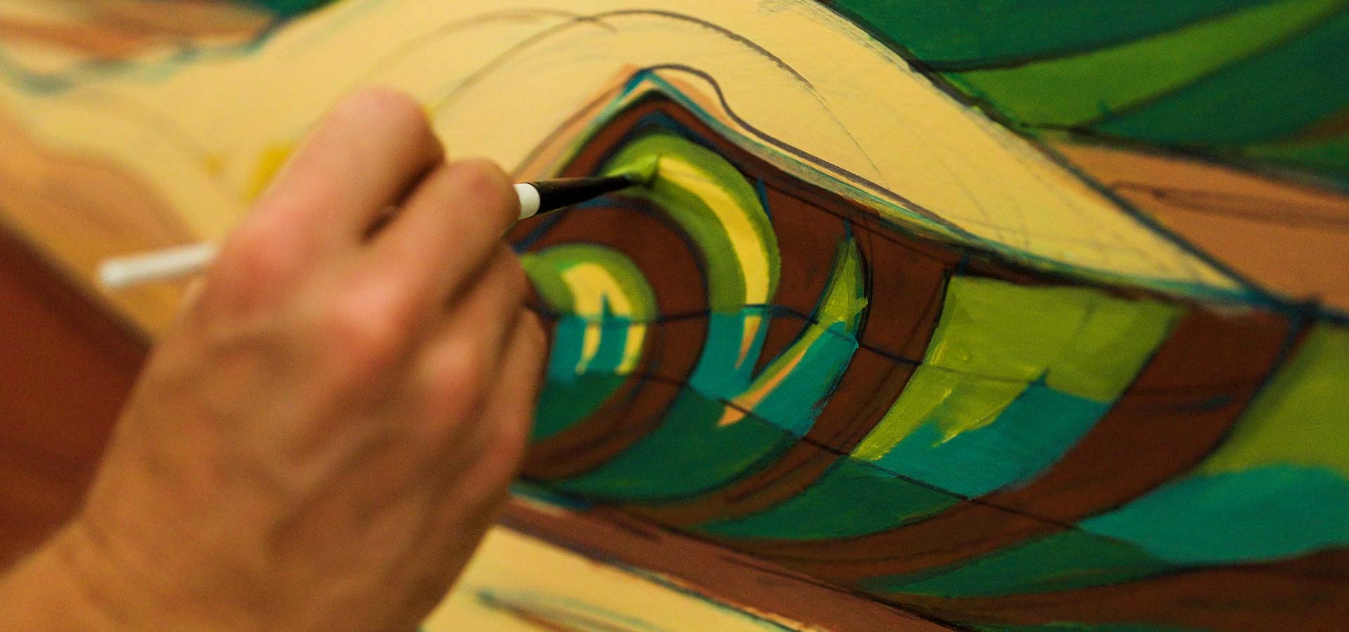 Close up of Erik Abel painting his artwork