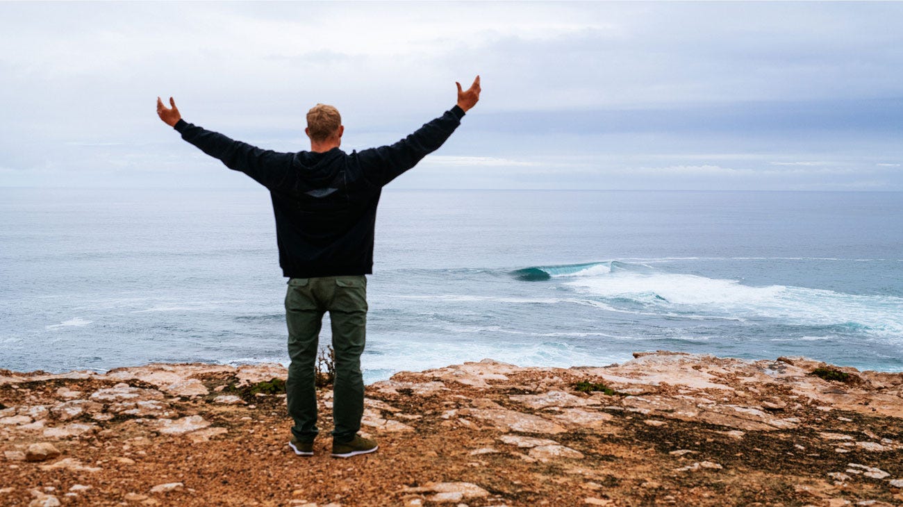 Mick Fanning standing on a cliff in SA