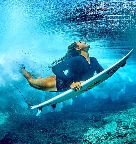 Brisa Hennessy duck diving for a wave