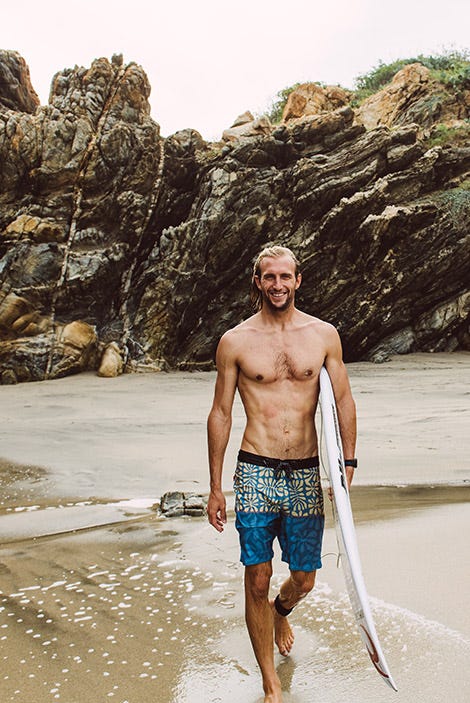 Owen Wright walking along the beach