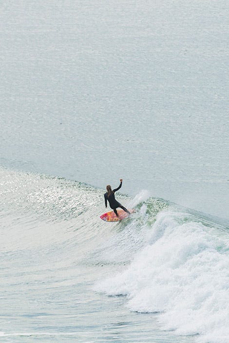 Rosy Hodge surfing a bottom turn on a wave