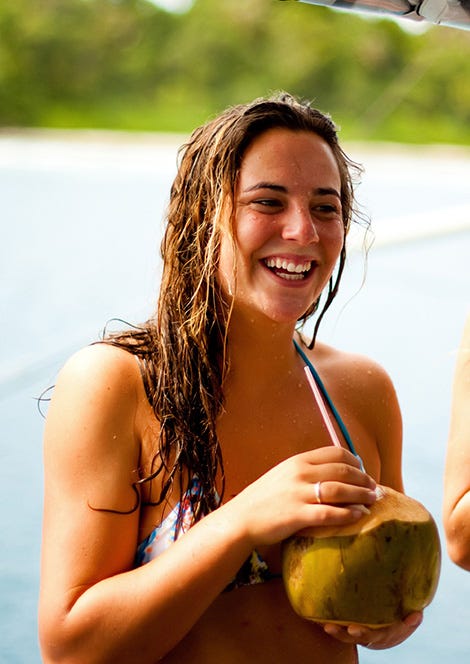 Candid image of Tyler Wright drinking from a coconut