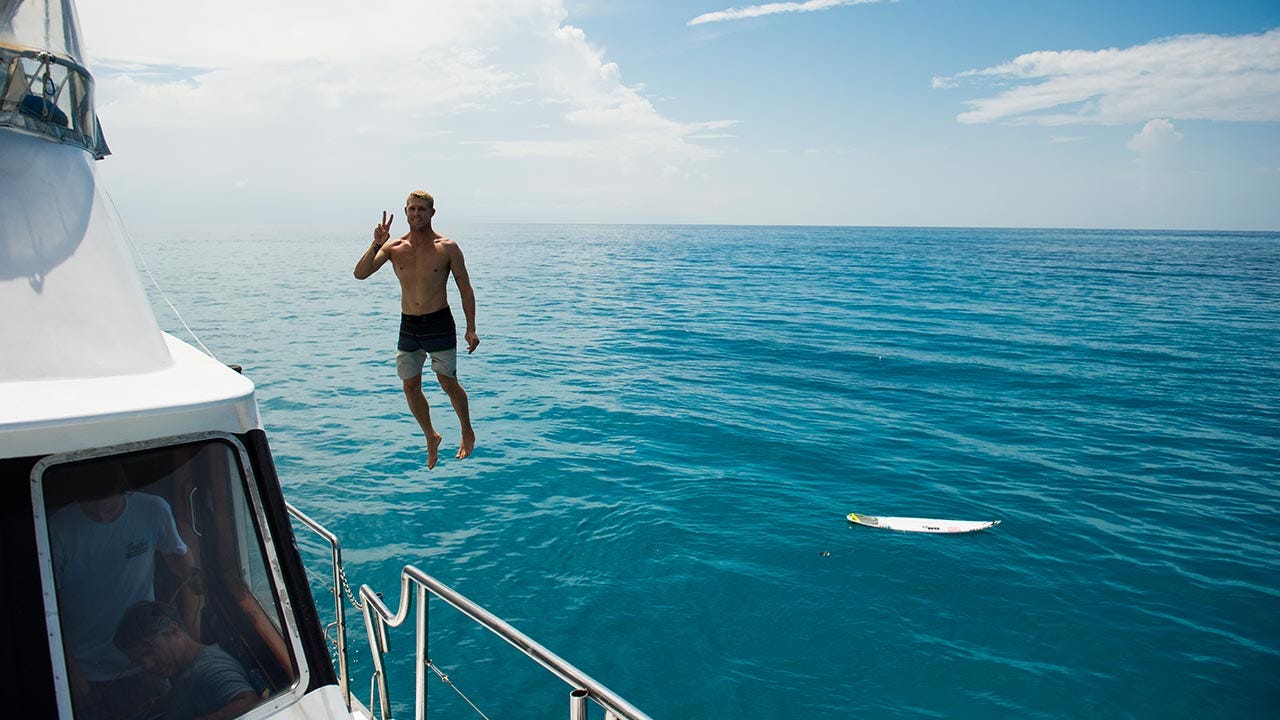 Mick Fanning jumping into water
