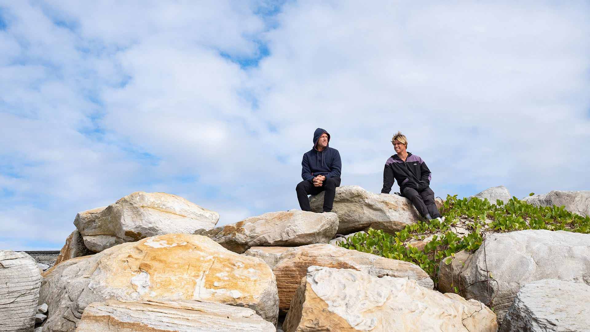 Morgan Cibilic sitting on a rock with Mick Fanning