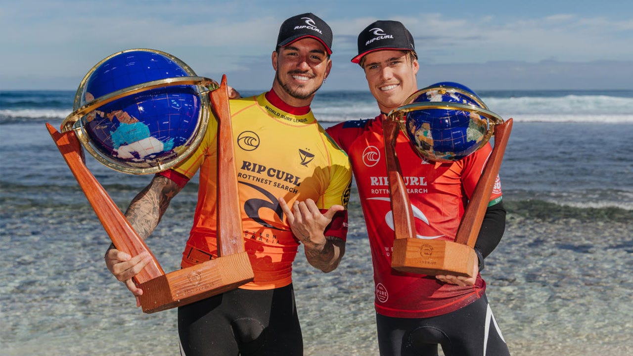 Morgan Cibilic and Gabriel Medina holding their trophies