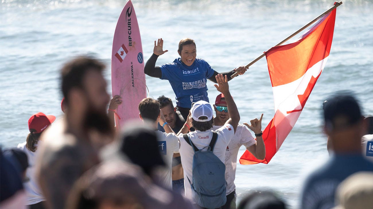 Victoria Feige being chaired by friends up the beach after her win