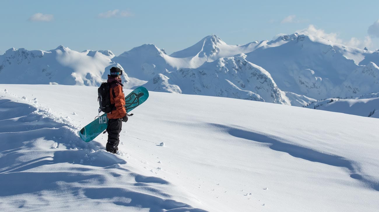 Chris Rasman standing with his board in the Canadian snow