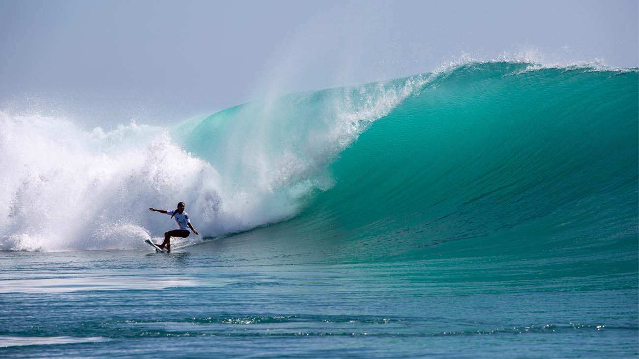 Lidia Kato doing a button turn on a wave at Padang Padang