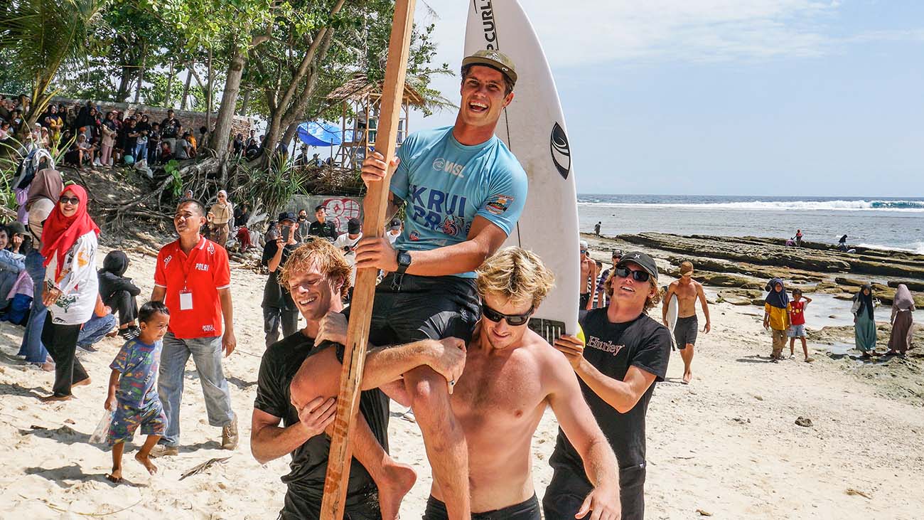 Morgan Cibilic being chaired across the beach after her win.