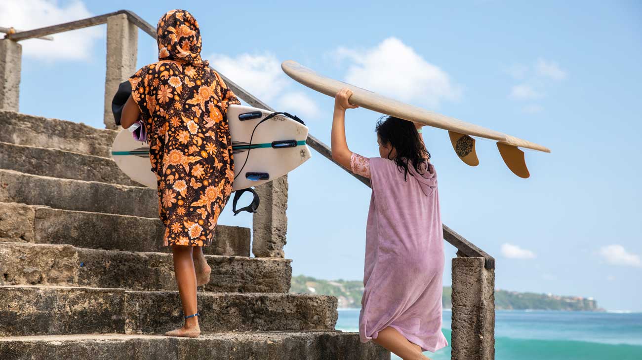 Rip Curl grom wearing a hooded towel on the beach in Bali