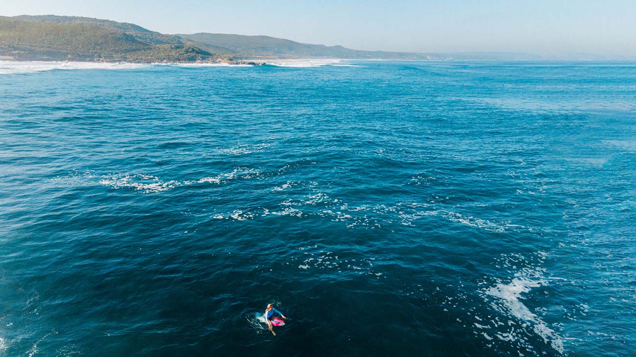 Rip Curl surfer paddling out. 