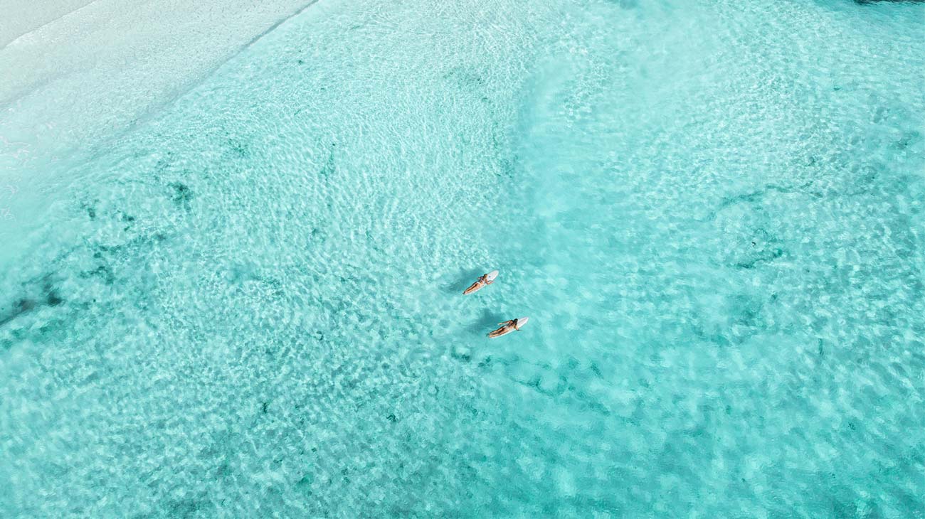 Women Paddling Out to Surf in Australia