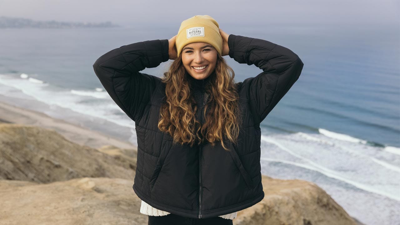 Snowboarder trekking up a mountain