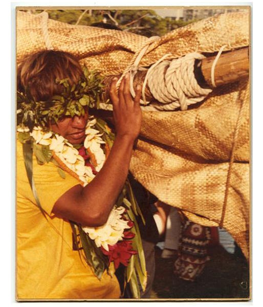 Eddie Aikau carrying a canoe