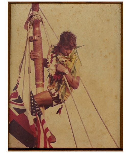 Eddie Aikau climbing up the sails on a boat
