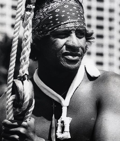 Close up black and white portrait image of Eddie Aikau