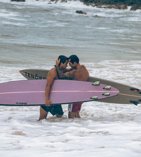 Two contestants hugging in the water