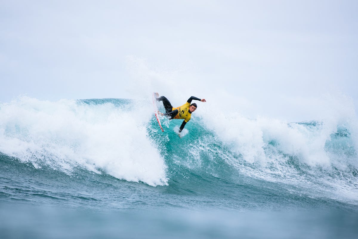 Griffin Colapinto surfing in his yellow jersey