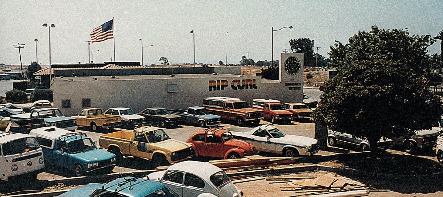 Building with rainbow Rip Curl logo and American flag, one of Rip Curl's first international licensees, in America in the 80's