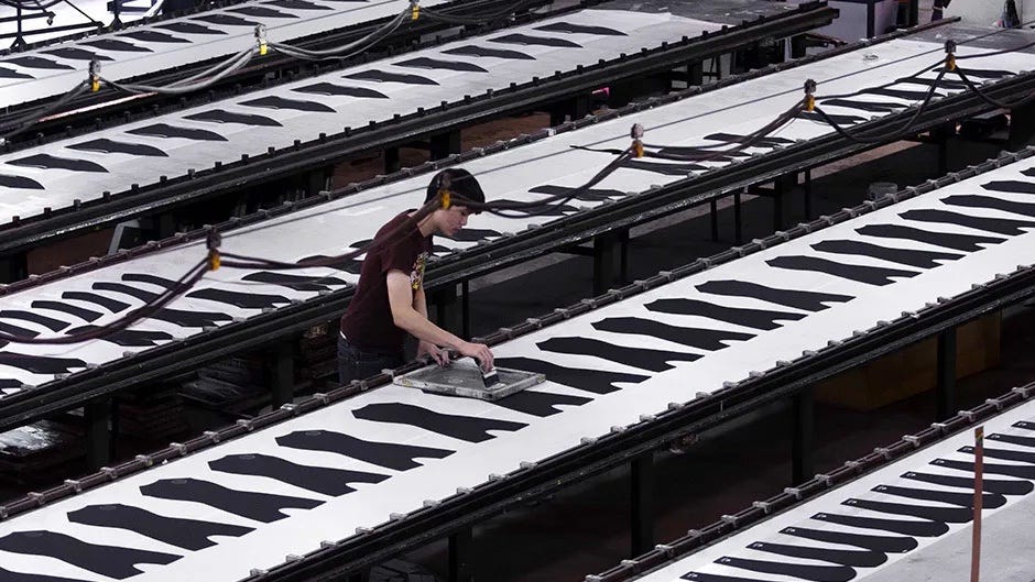 A Rip Curl crew member works on products in the factory