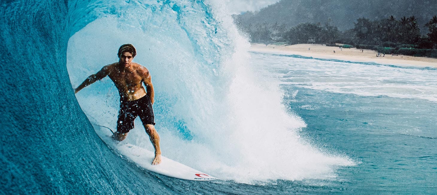 Morgan Cibilic getting barrelled by a wave. Image links to video of Morgan surfing in Rip Curl's 3-2-one boardshorts