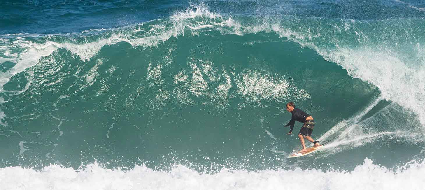 Tom Curren riding a wave. Image links to short film: Free Scrubber, starring Tom Curren