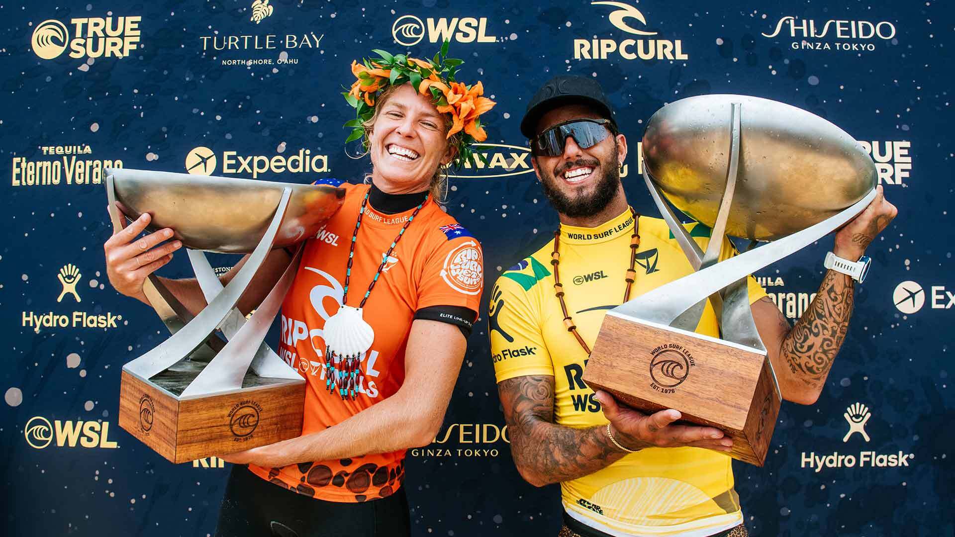 Steph Gilmore and Filipe Toledo holding their trophies