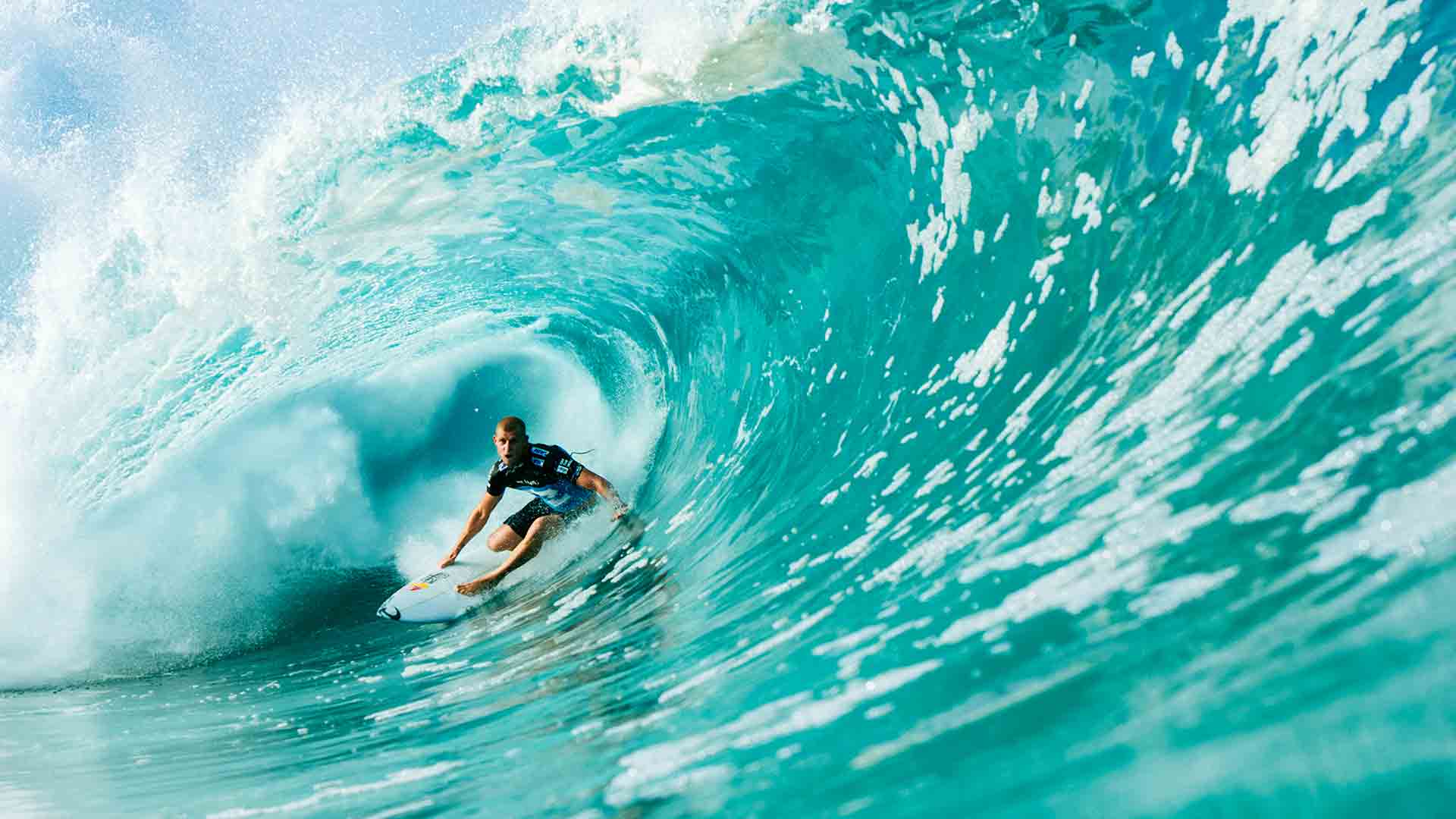 Mick Fanning getting barrelled surfing the Mirage Activate Boardshort