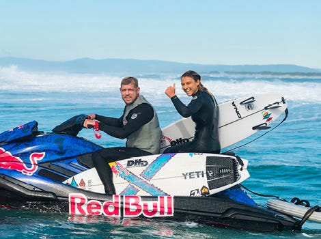 Molly Picklum on the back of a jetski with Mick Fanning