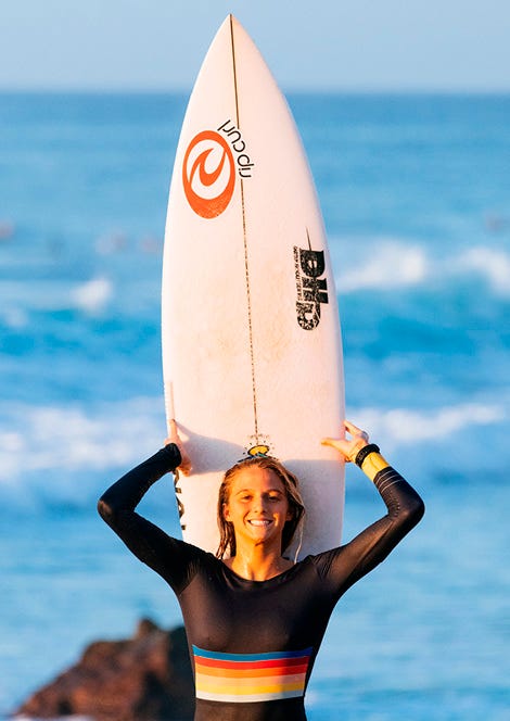 Molly Picklum holding up a surfboard