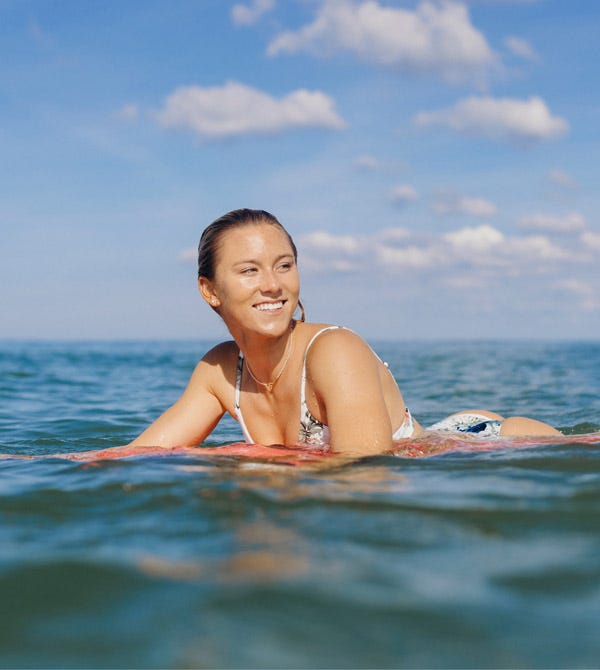 Alyssa Spencer paddling out in Hawaii