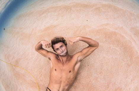 Crosby Colapinto laying on the sand underwater