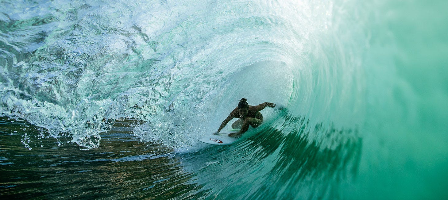 Brisa Hennessy getting barrelled by a wave. Image links to video of interview with Brisa for Rip Curl's My Bikini campaign